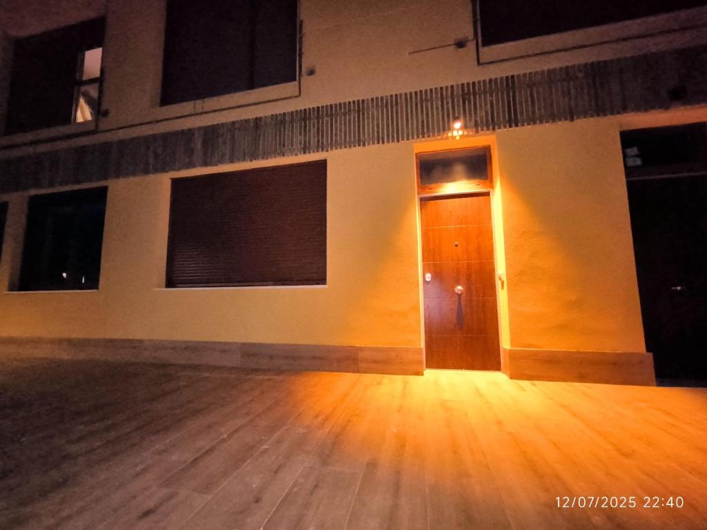 an empty room with a door and a wooden floor at Apartamento La Mandrágora in Arenas de Cabrales