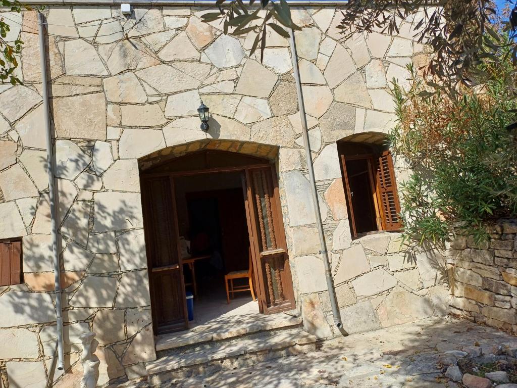 an entrance to a stone building with a door at Vocation Rest House in Anogyra in Anoyira