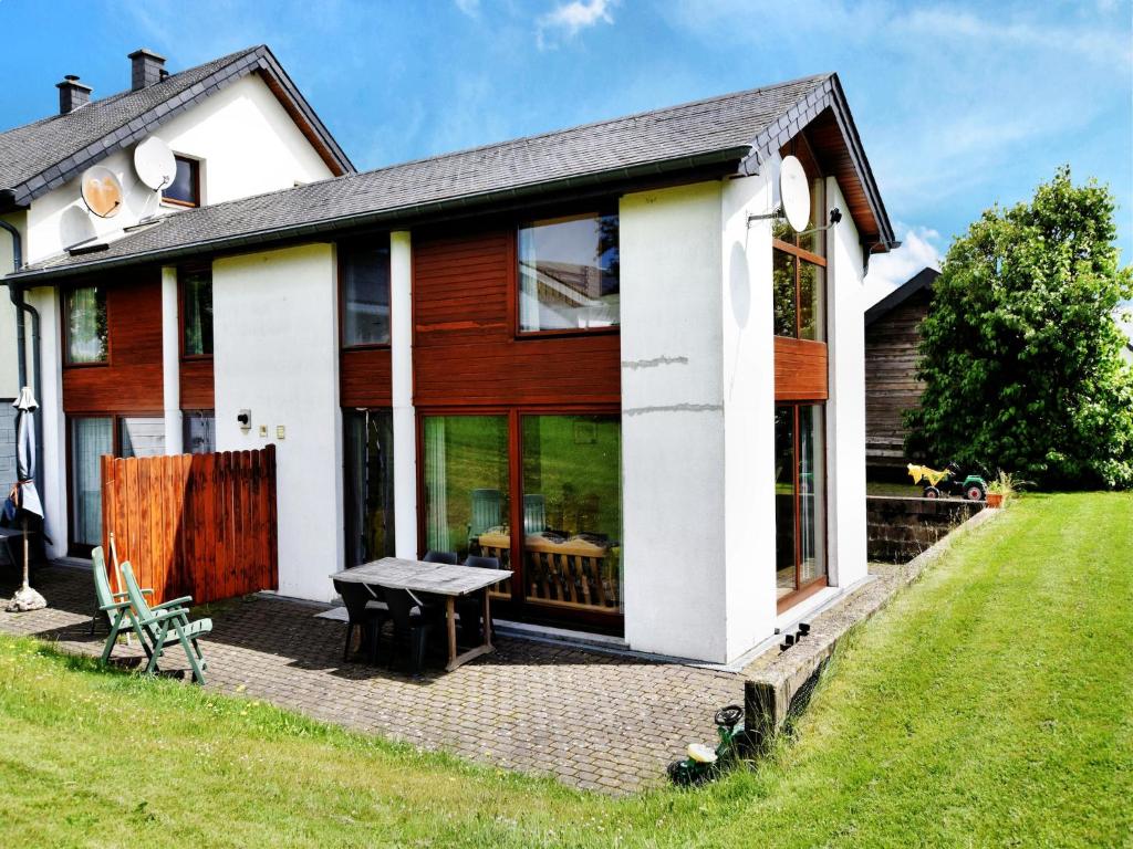 a house with a picnic table in front of it at Holiday Home in St Vith with hot tub in Amelscheid