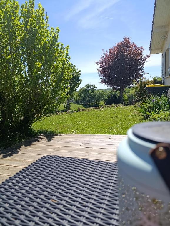a toilet sitting on a patio with a yard at Au fil des mains in Le Houga