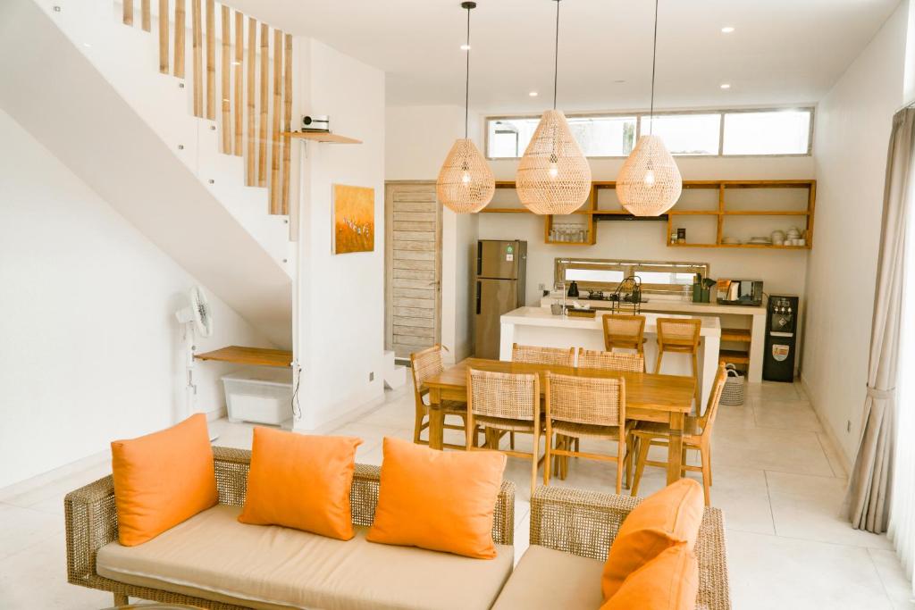 a living room with a couch and a dining room at Casa Solisa in Kerobokan