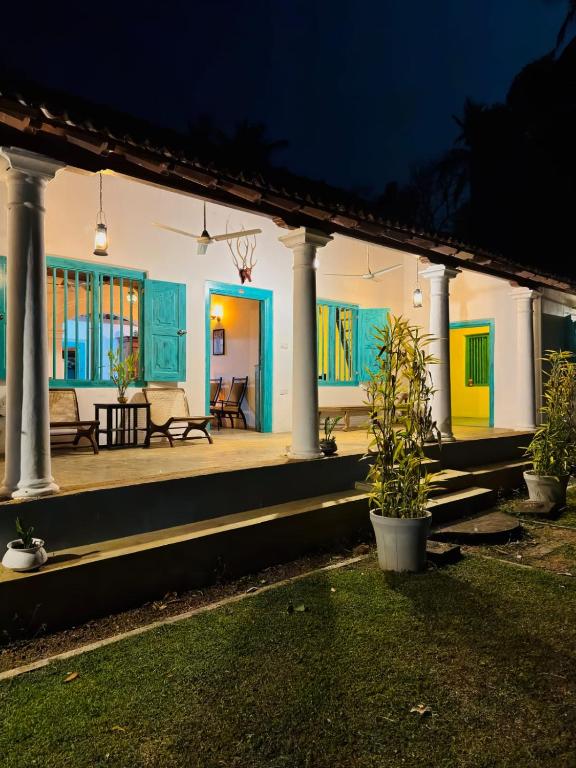 a porch of a house at night at Villa Ceylora in Busse