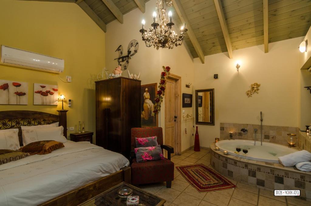 a bedroom with a bed and a bath tub at Zemer Lodging in Sede Eli‘ezer