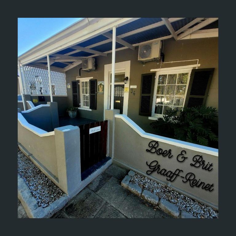 a house with a sign that reads lost and hit just return at Boer & Brit, Graaff-Reinet in Graaff-Reinet