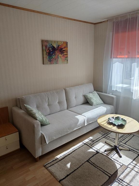 a living room with a couch and a table at Retrokodu in Rakvere