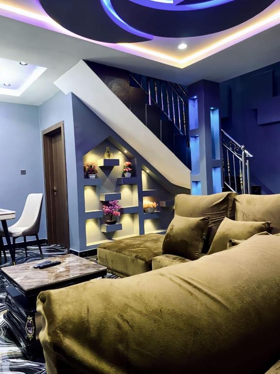 a living room with a couch and a table at Spike apartments in Jibowu
