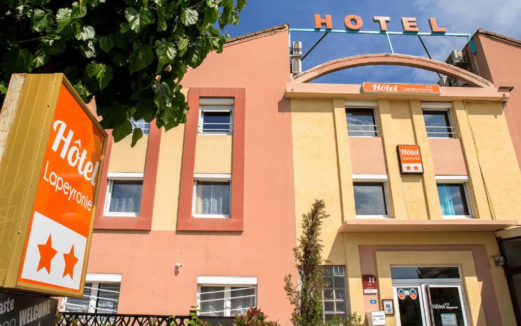 a hotel sign in front of a building at Hôtel Lapeyronie in Montpellier