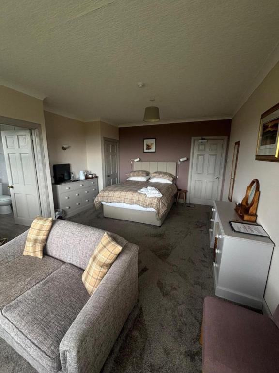 a living room with two beds and a couch at The Greannan Bed & Breakfast in Blackwaterfoot