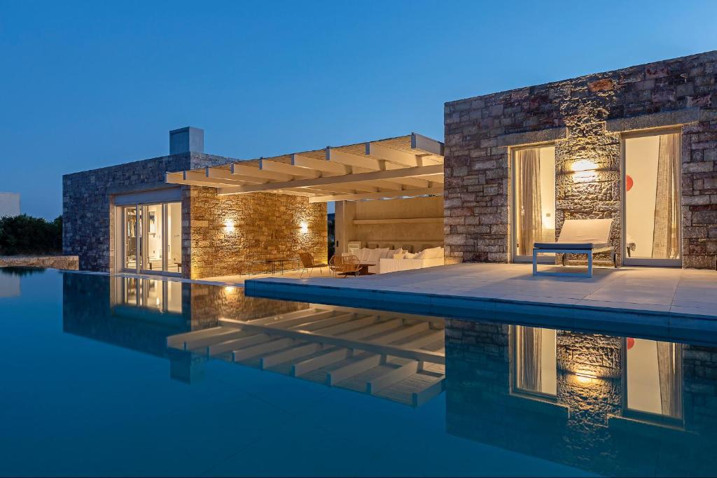 a house with a swimming pool at night at Villa Paleopoli in Kythira