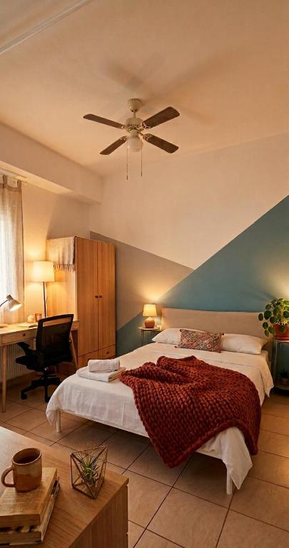 a bedroom with a bed and a ceiling fan at Maria's Studio No3 in Heraklion in Thérissos