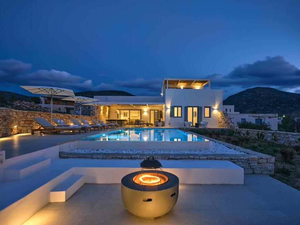 a villa with a swimming pool at night at Villa Katy in Aspro Chorio Paros