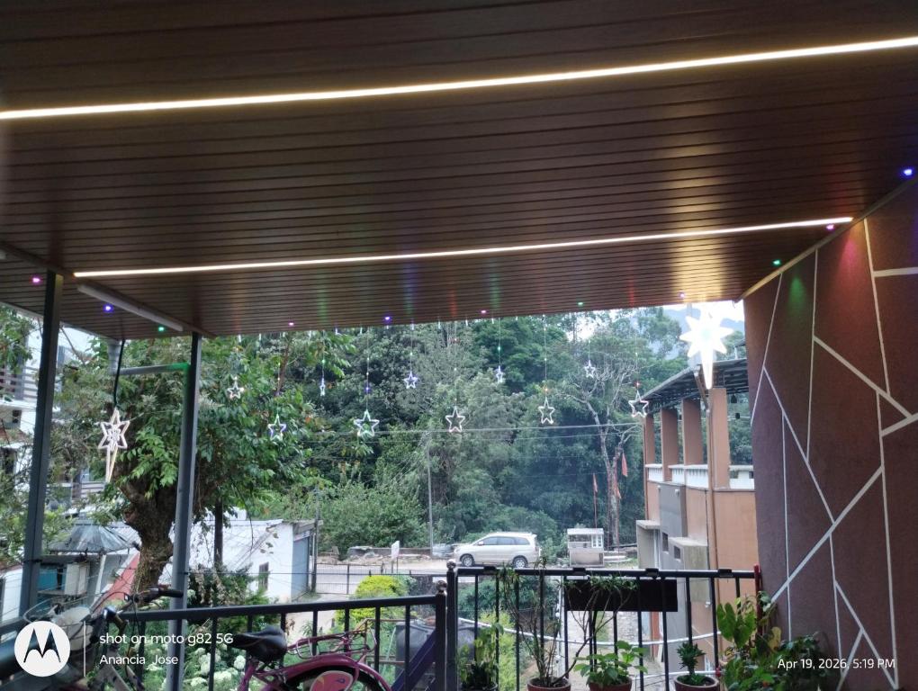 awning over a balcony with a view of a street at Star Cottage DVM in Munnar