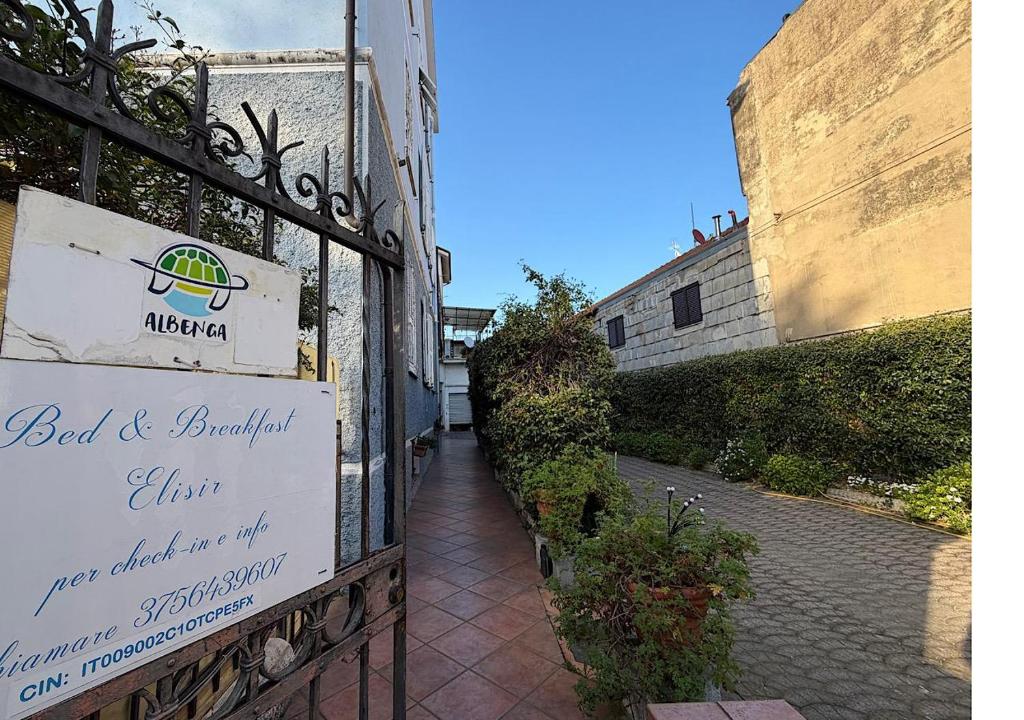 a sign for a bed and breakfast sign on a building at B&B Elisir in Albenga