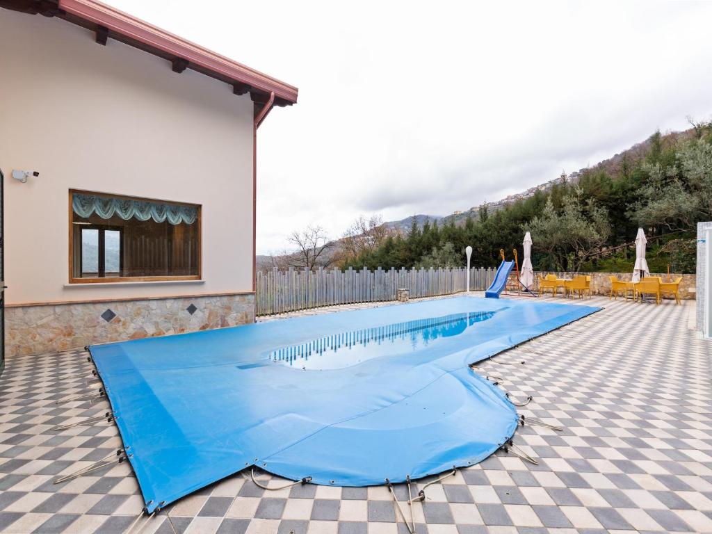 a large blue swimming pool in a yard at Villa in San Mango with Pool and Hot Tub in San Mango dʼAquino