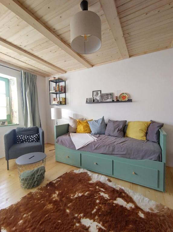 a bedroom with a bed and a chair in a room at Mera Small House in Mera