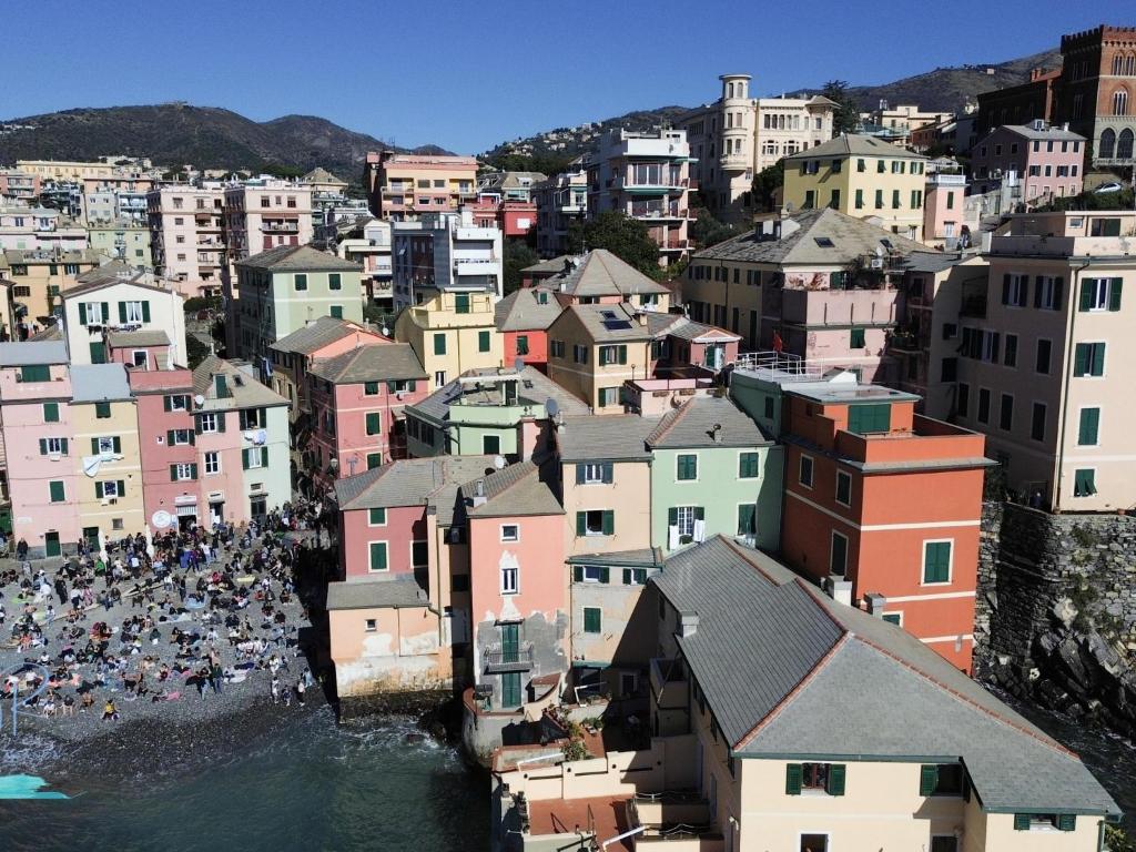 a city with a bunch of buildings and a crowd of people at Ochin de Ma' a Boccadasse - Genovainrelax in Genoa