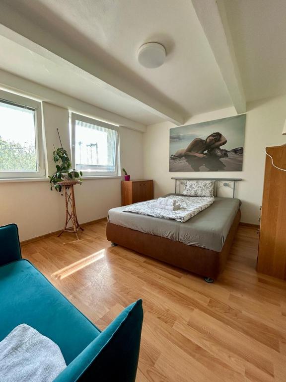 a bedroom with a bed and a couch at Nový park in Nitra