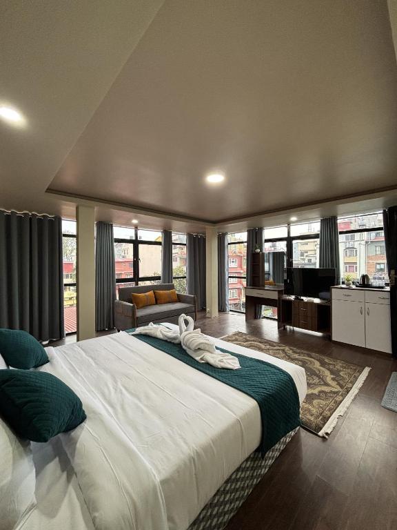 a large bedroom with a large bed and a living room at Anamnagar Union House in Kathmandu