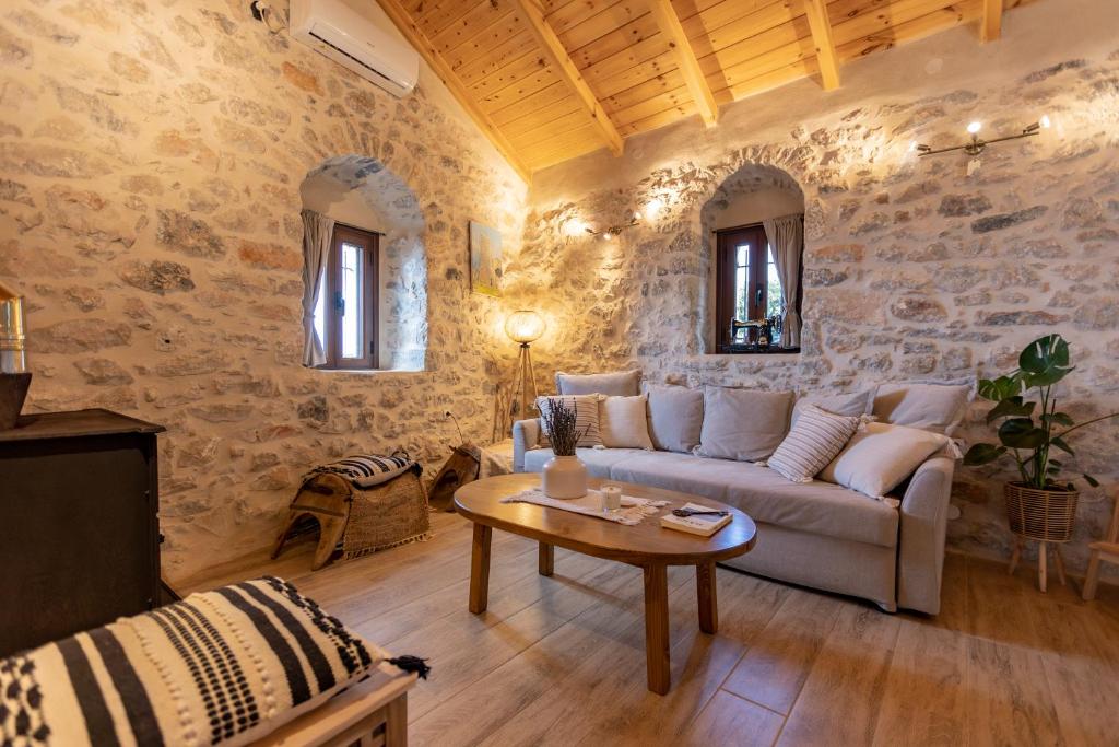 a living room with a couch and a table at Anemolithos Mani's House in Areopoli