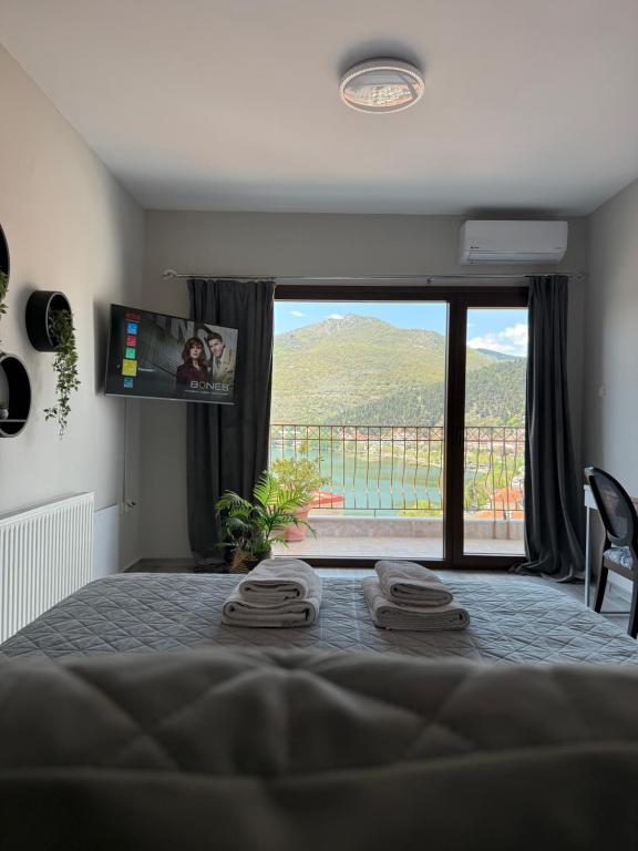 a bedroom with a bed with a view of a mountain at Panoramic suite in Kastoria