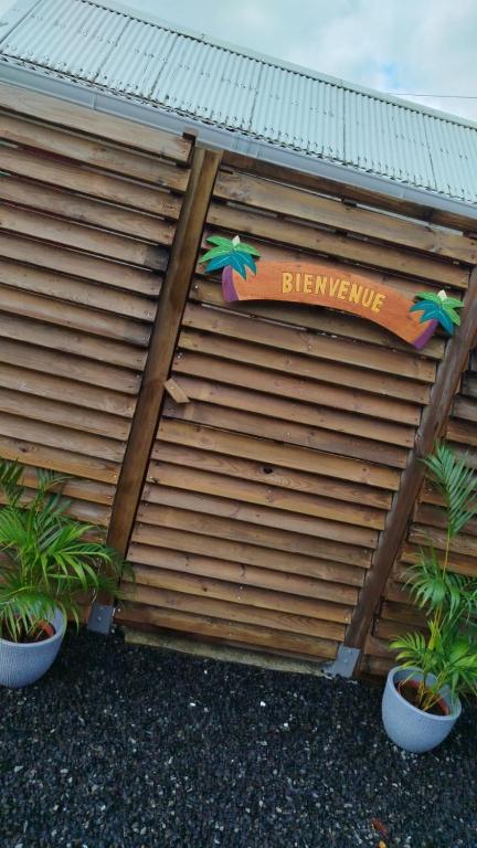 a building with a sign that reads berniversary at Domaine kaliope in Le Robert