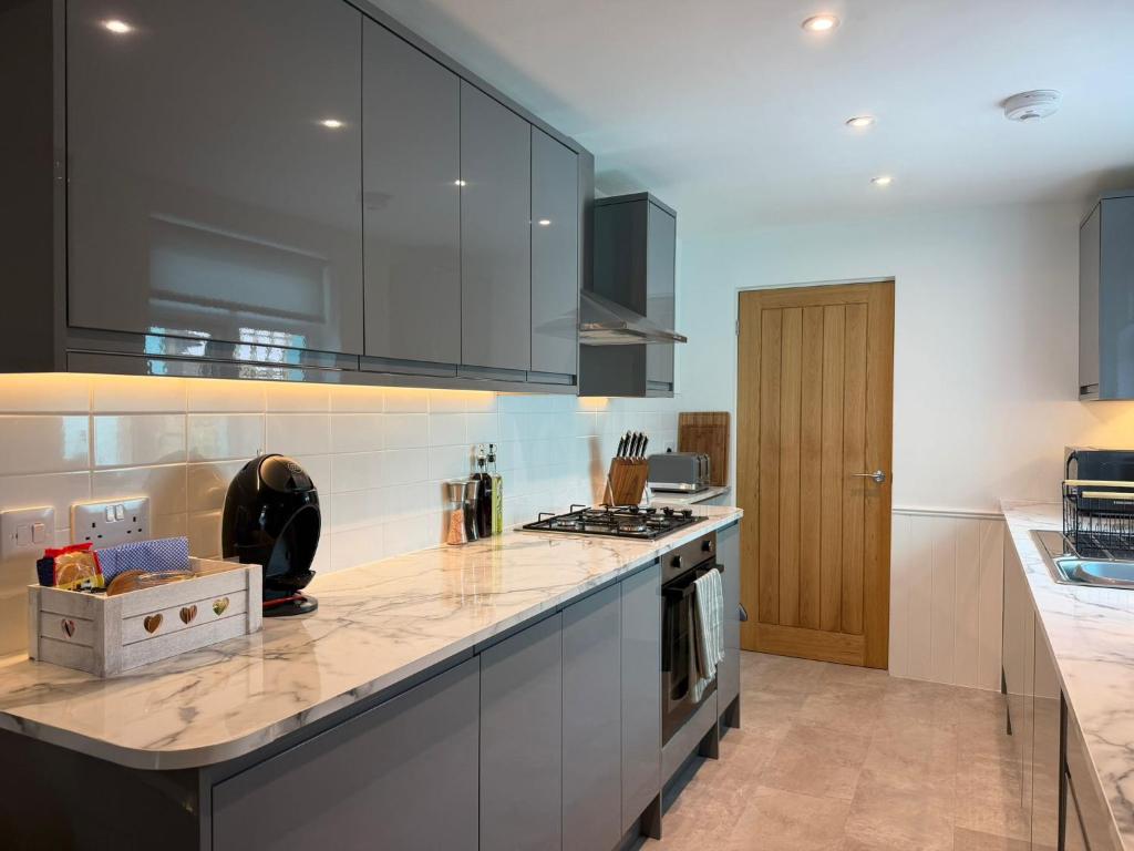 a kitchen with a counter top and a stove at Cockle Cottage in The Mumbles