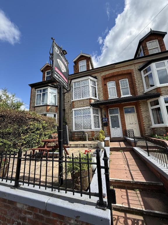 a brick house with a sign in front of it at Diamonds Guest House in York