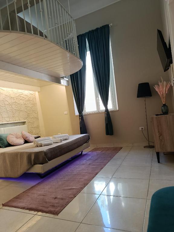 a bedroom with a bed and a large window at Casa vacanze So Suite 24 in Reggio di Calabria
