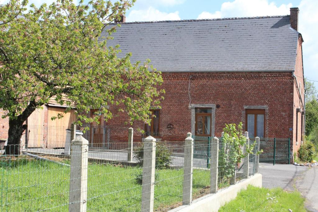 an old brick house with a fence in front of it at Country house in Erloy, Oise valley in Erloy