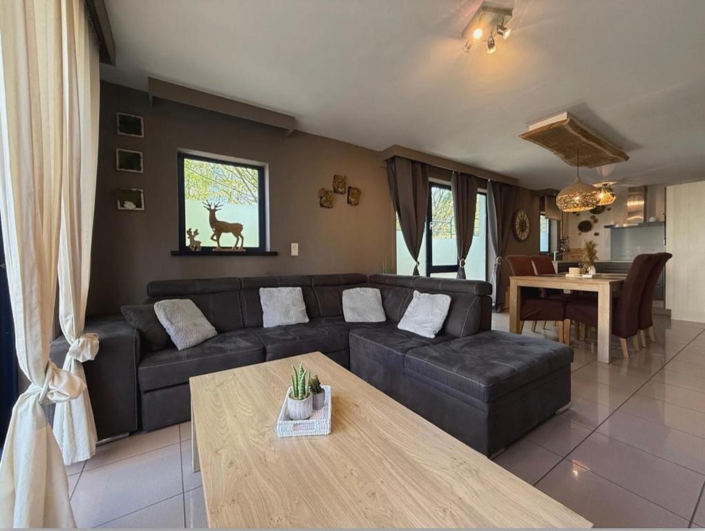 a living room with a couch and a table at Noax gite Durbuy in Durbuy