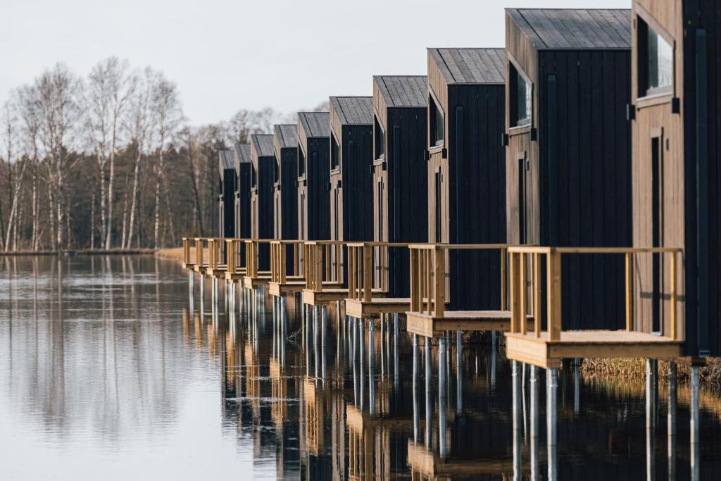 a row of houses sitting on a body of water at WAKE INN by Pidu-LA in Abula