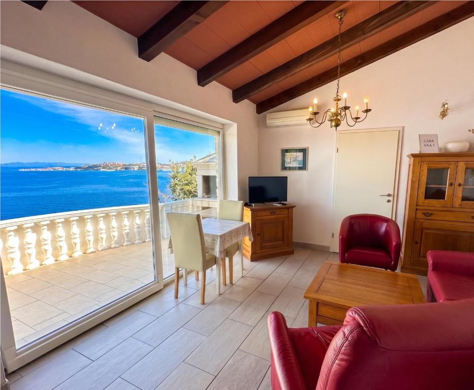 a living room with a table and a view of the ocean at Casa Ana Istria 1 in Savudrija