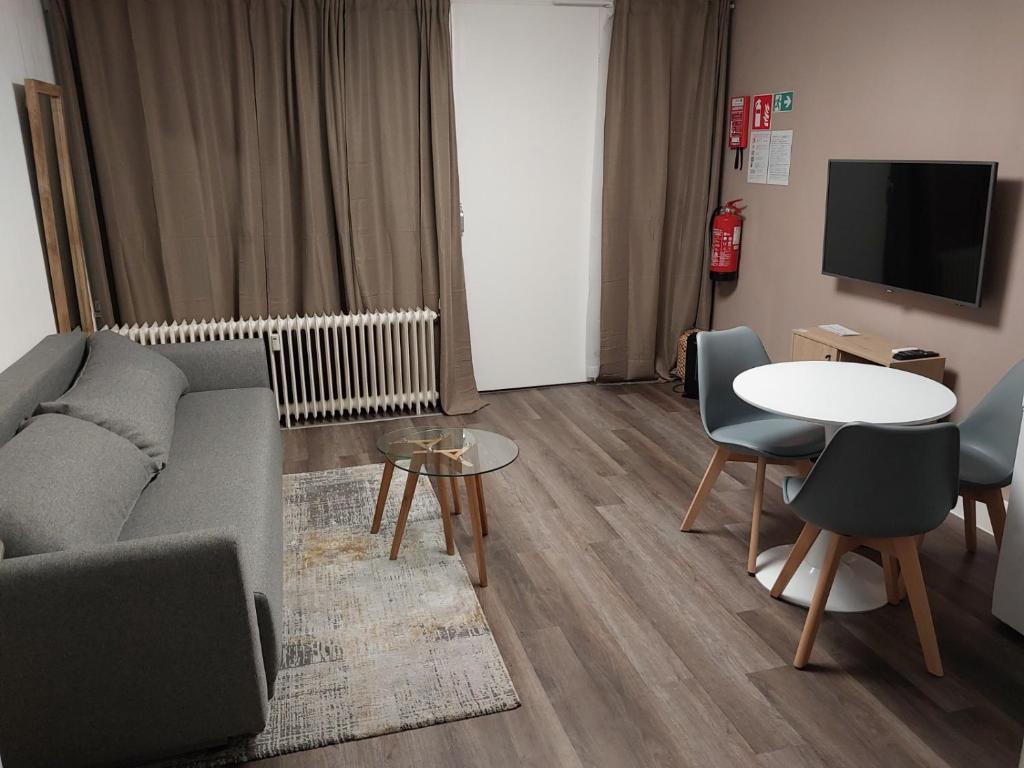 a living room with a couch and a table at Maison-Home-ZuHause in La Calamine