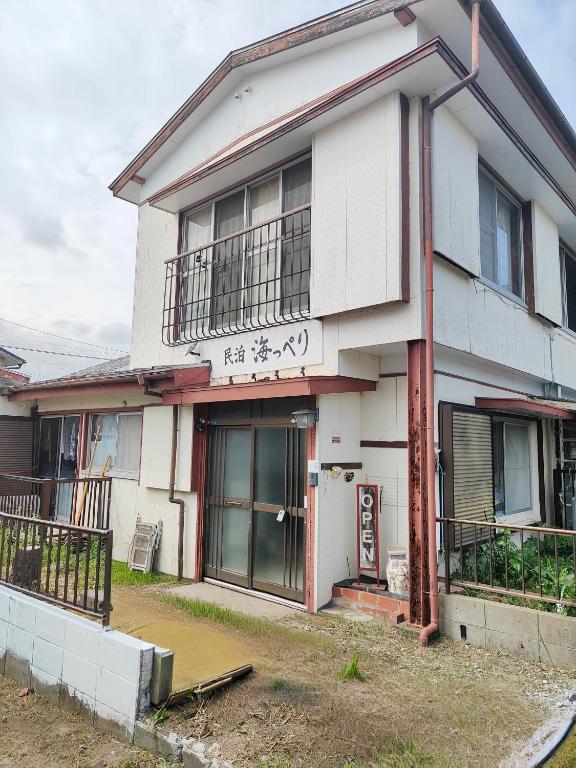 a white building with writing on the side of it at 海っぺり宮崎 in Miyazaki