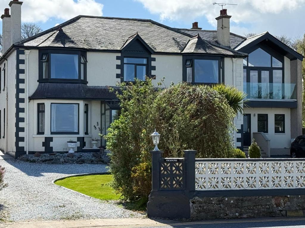 a house with a fence in front of it at "SUPERB-SEA-VIEWS"ROOM ONLY at WETHERBY NAIRN in Nairn