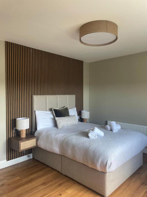 a bedroom with a large bed with two lamps on it at Glasha Meadows Accommodation in Doolin