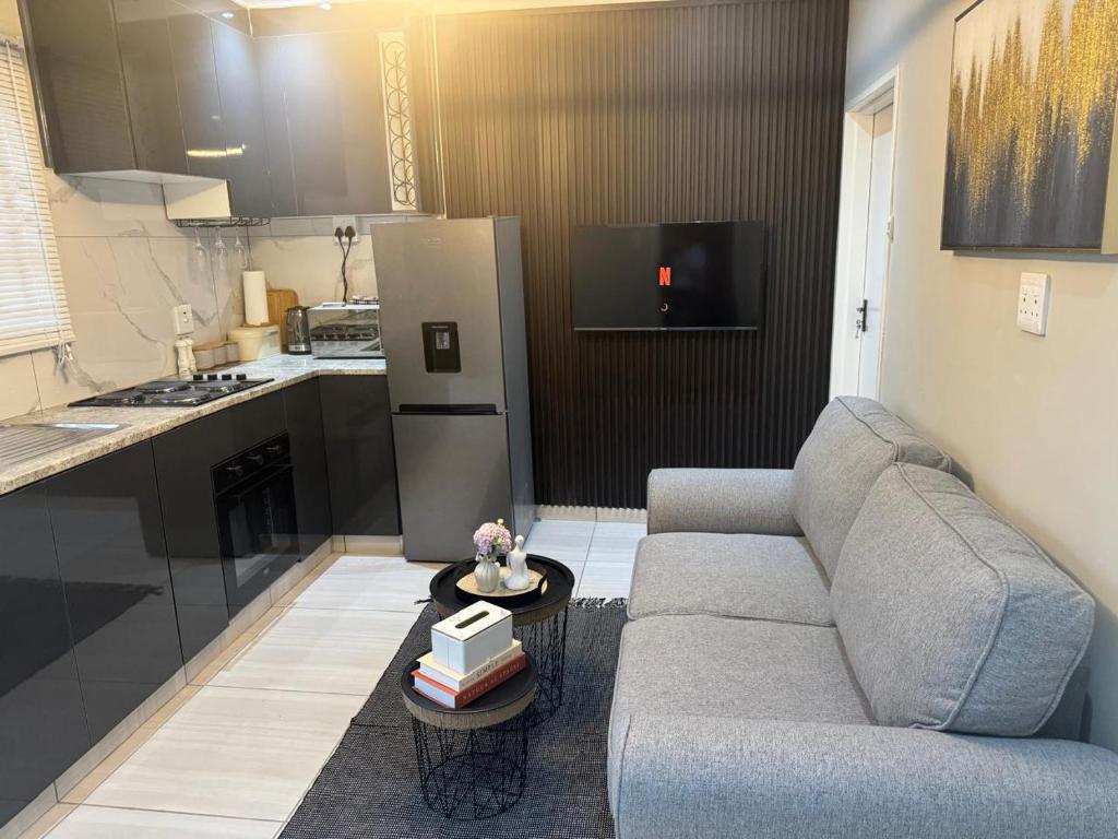 a living room with a couch and a kitchen at 3 on Eland in Vryheid