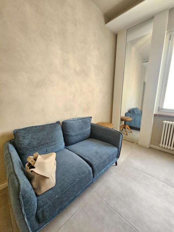 a blue couch sitting in a living room at Locazione turistica Corner 20 zona Clinica Piacenza in Piacenza
