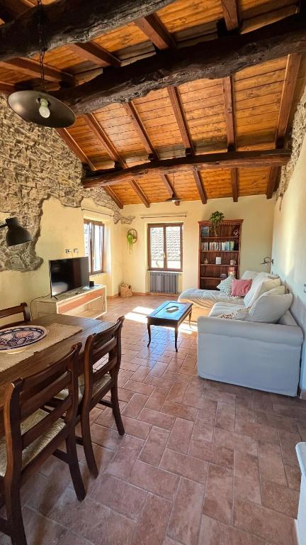 a living room with a couch and a table at Ancient townhouse next castle in Vezzano Ligure