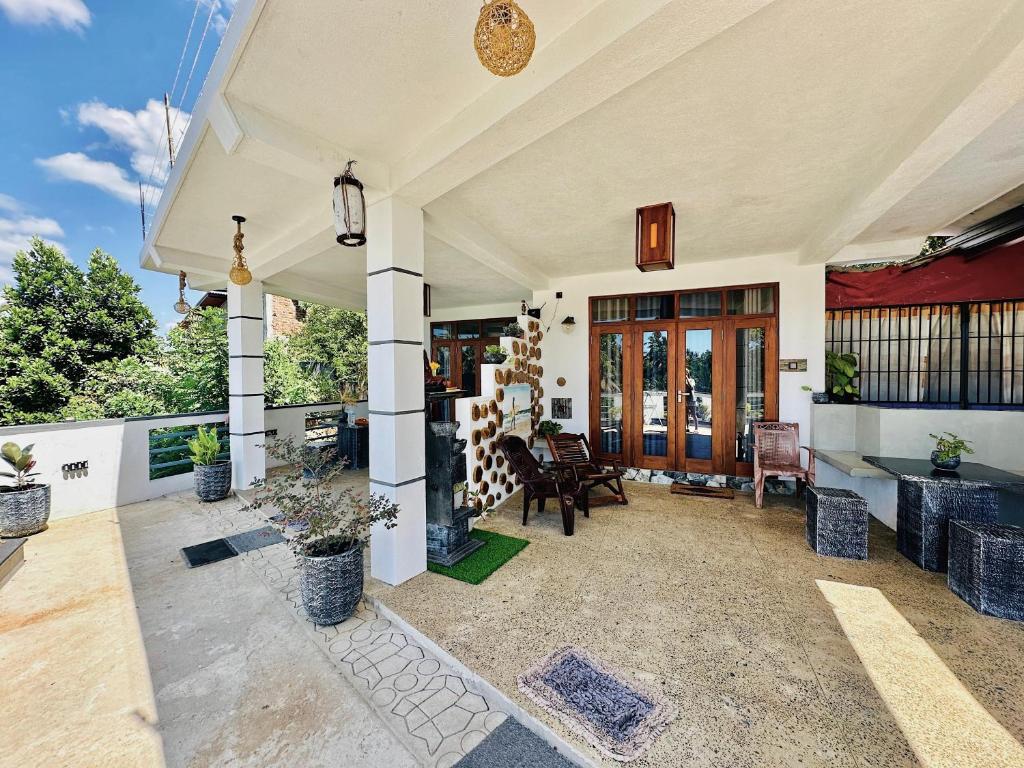 a home with a patio with chairs and tables at Hiri First In Rest in Dickwella