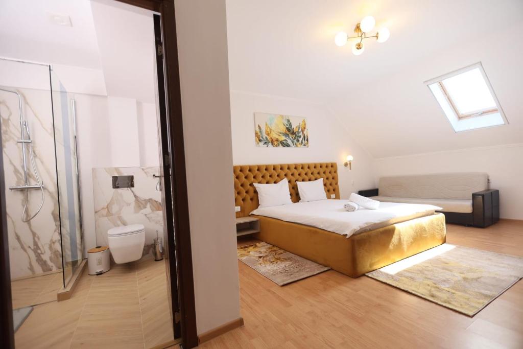a bedroom with a king sized bed and a sliding glass door at Pensiunea Cavaler in Baile Felix