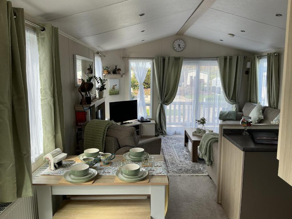 a living room with a table and a couch at Hares Haven pet friendly sleeps 6 in Patrington
