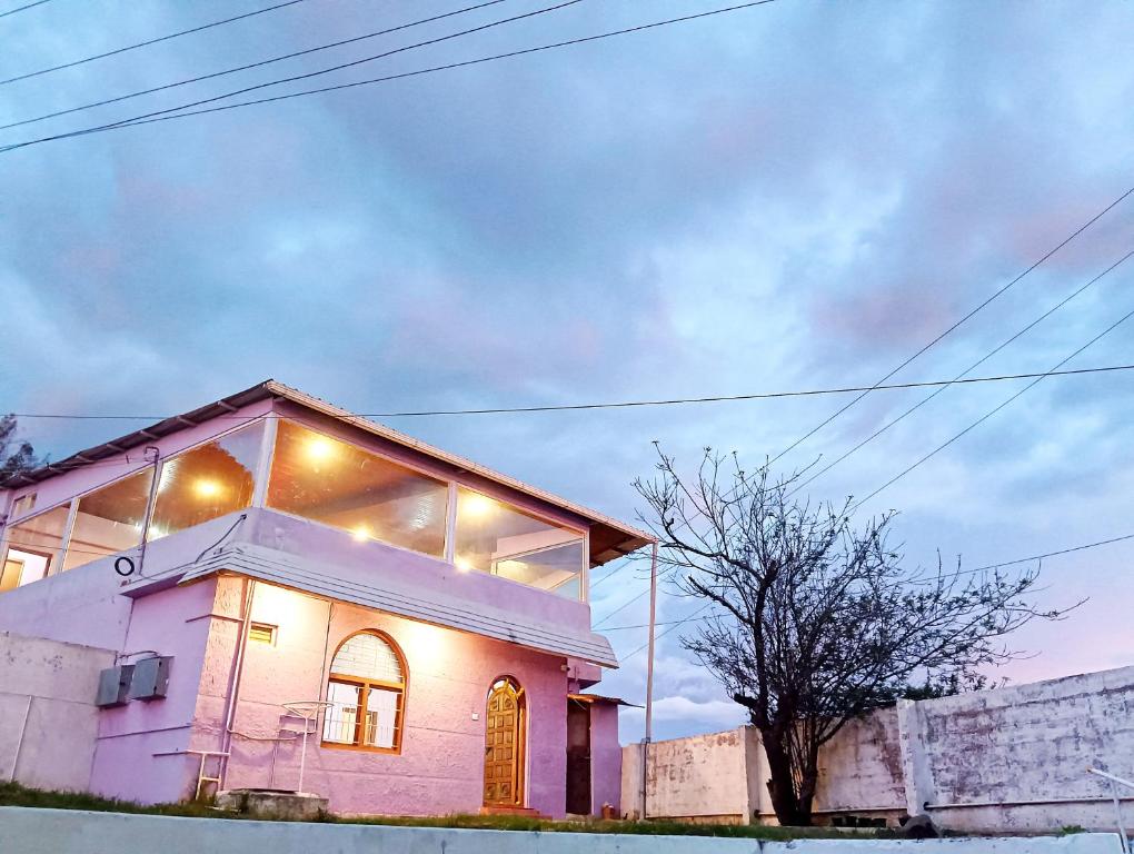 a pink house with lights on top of it at Ooty Gate Residency in Ooty