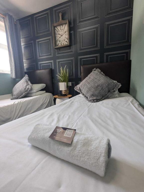 a hotel room with a bed with a book on it at The Crafty Cow in Bristol