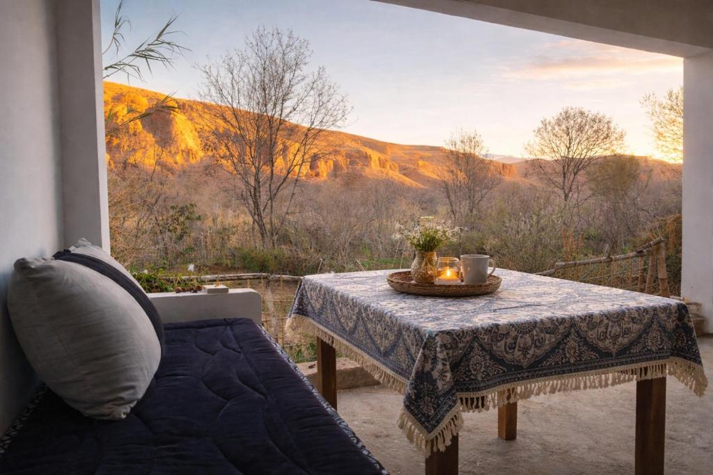 a table on a patio with a view of a mountain at Chez BABAYO BY DADES in Zaouïet Sidi Daoud