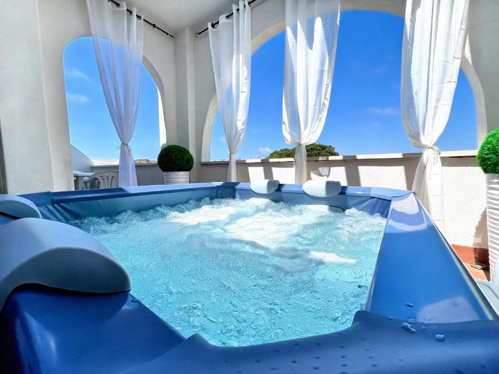 a hot tub in the middle of a patio at Kalispera Residence in Scalea