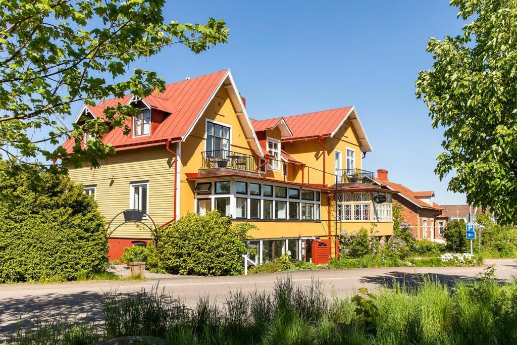 a large yellow house with a red roof at Apartment in central Båstad in Båstad