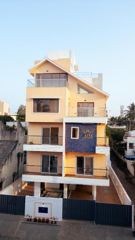 a yellow building with a sign on the side of it at 46 Elite Enclave in Nashik