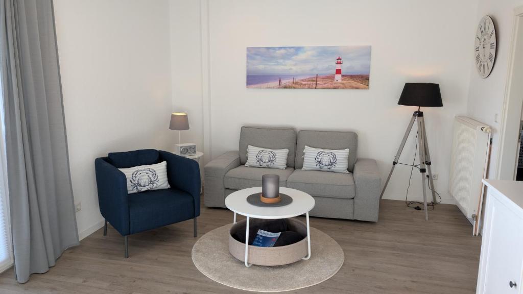 a living room with a couch and a table and a lighthouse at Das Inselhaus in Norddeich