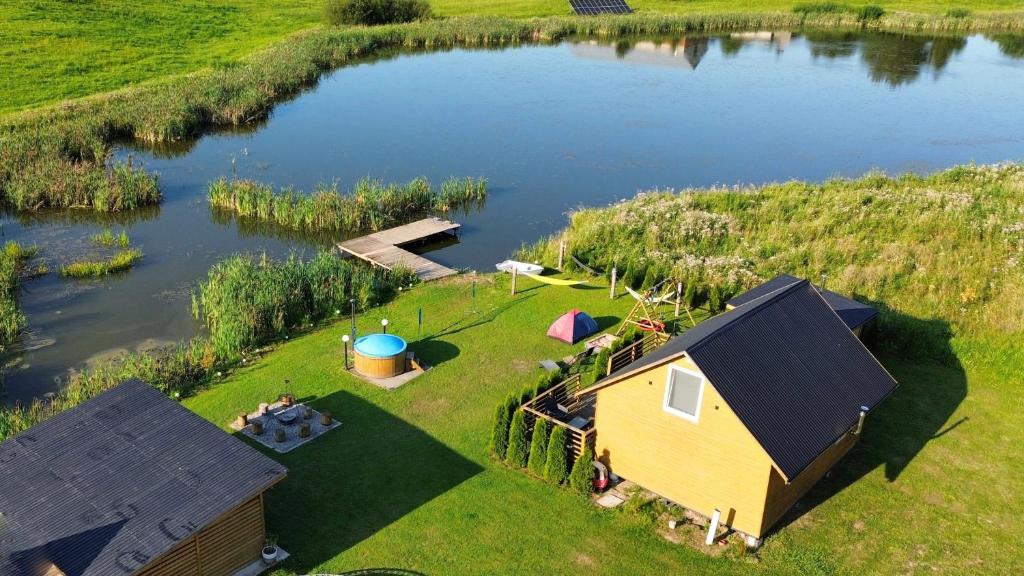 an aerial view of a cabin on a lake at Dom BAnia Mazury SPA in Kukowo
